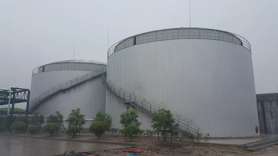Large anaerobic treatment tanks with access stairs and service platforms