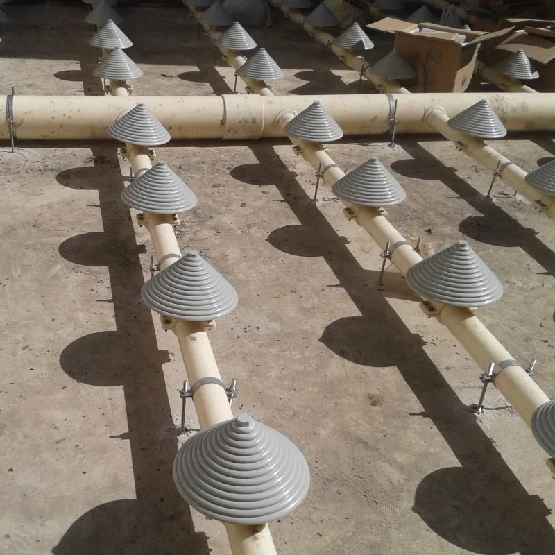 Close-up of tower-type diffuser heads installed on air-distribution piping at a construction site